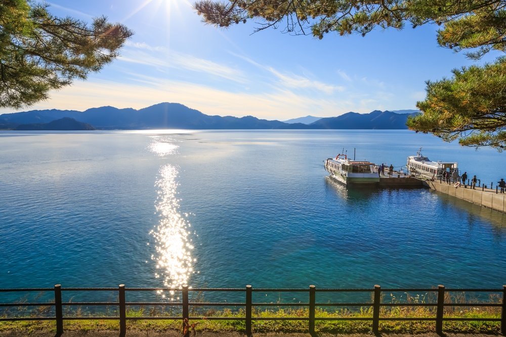 Passenger ships with sparkling sunshine in Lake Tazawa